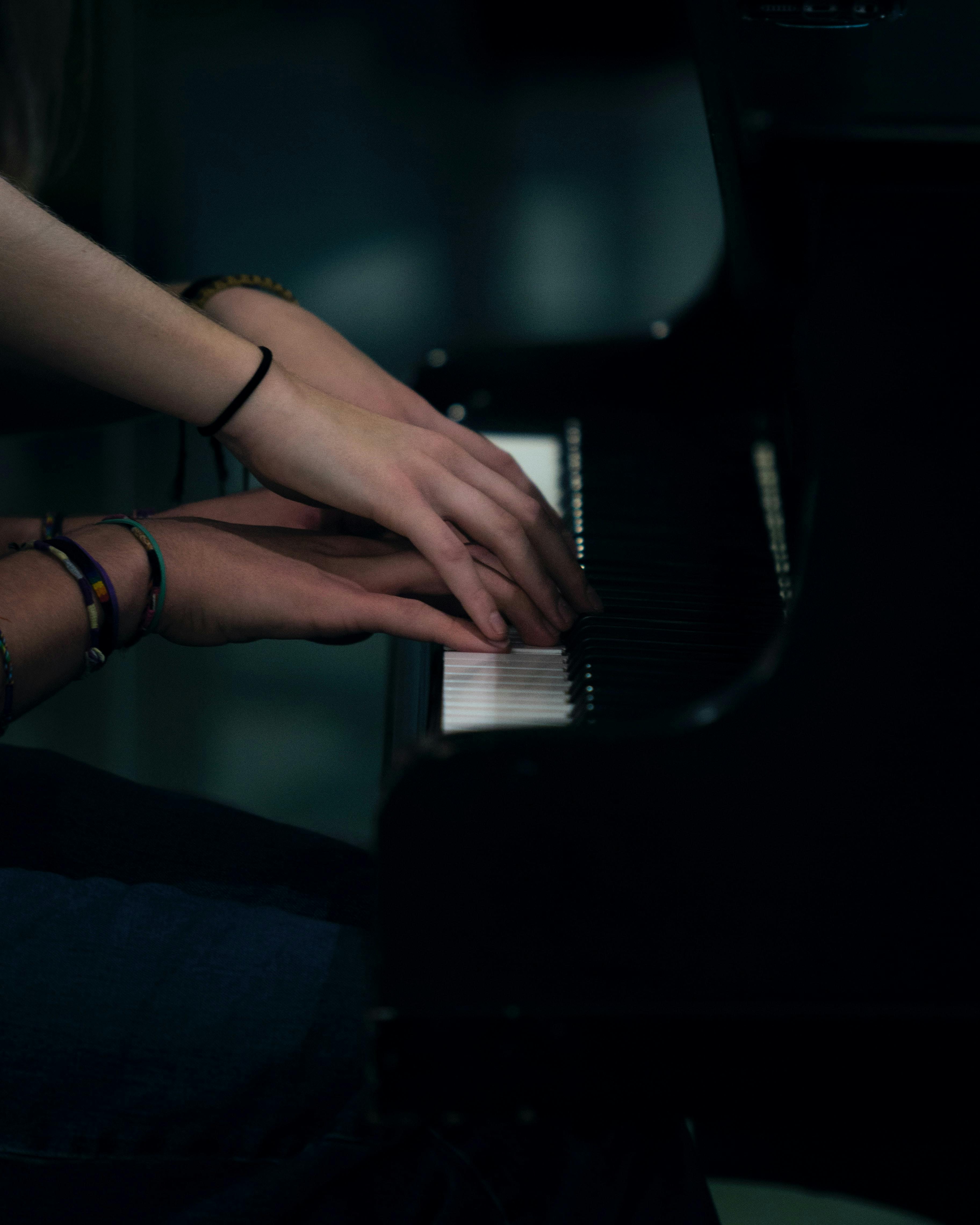 Four hands on a piano